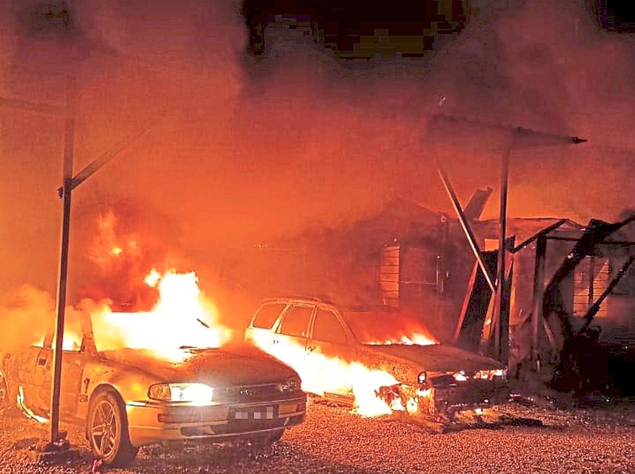 Deadly blaze: The fire destroyed a house as well as damaged three cars and three motorcycles. — Photo courtesy of the Raub Fire and Rescue Department’s Facebook page
