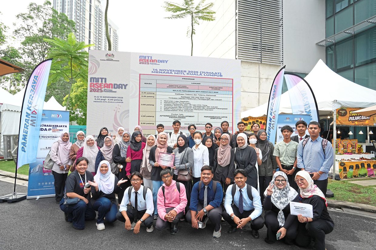 (Second row, sixth from left) Mida industry talent management and expatriate division director Azrina Hashim presenting a certificate of appreciation to Politeknik Sultan Salahuddin Abdul Aziz Shah industrial relations and training officers Amirah Mohd Arif (in grey) and Loh Yin Niee (in white) at “Eksplorasi Kerjaya Mida” 2025.