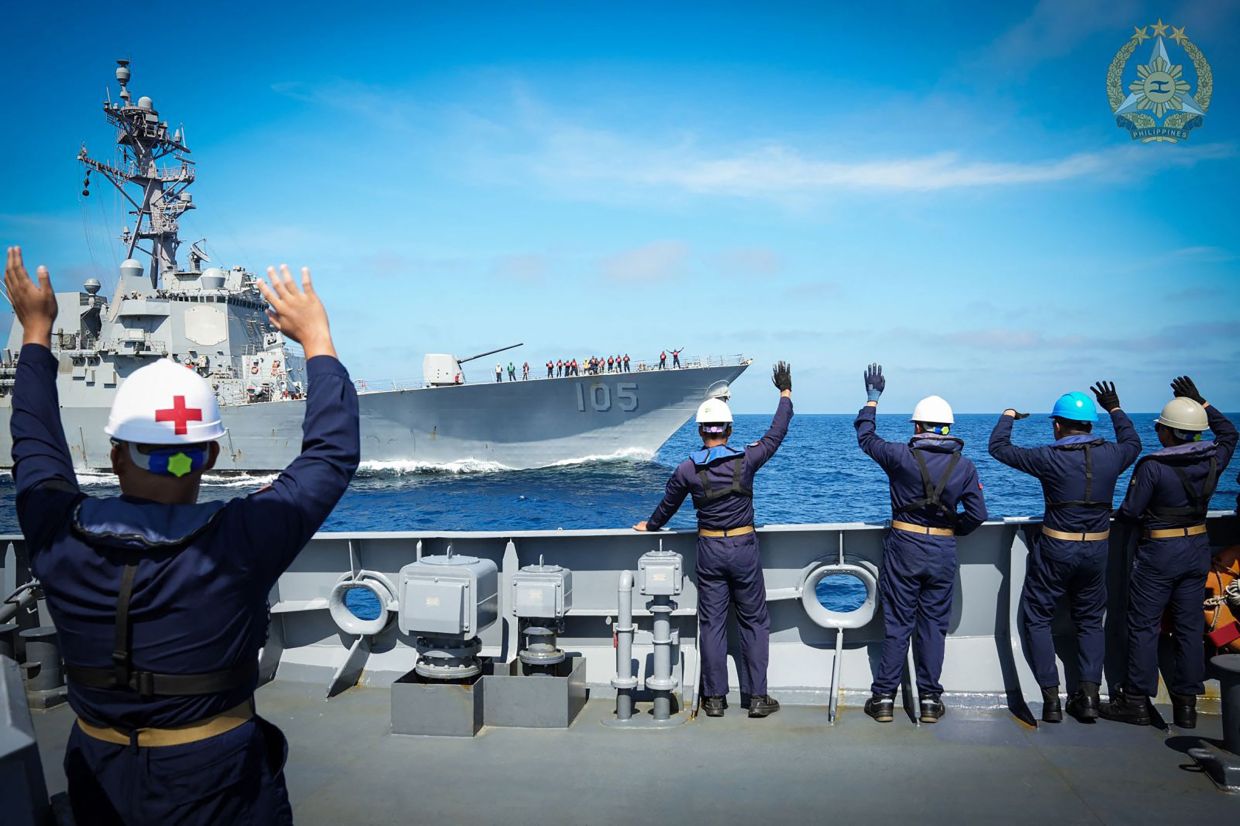 Personnel from BRP Antonio Luna (FF151) waving to Arleigh Burke-class guided-missile destroyer USS Dewey (DDG 105) (back) sailing past during a joint military exercise in the disputed South China Sea. The Philippine, US, and Japanese militaries this week conducted joint exercises near the Bashi Channel that separates the archipelago nation from Taiwan, officials said on February 27. Aircrafts from the three nations patrolled over the Philippines' northernmost Batanes islands in drills aimed at showcasing their ability to operate seamlessly together in complex maritime environments, the Philippine military said in a statement. -- Photo by Handout / Armed Forces of the Philippines-Public Affairs Office - AFP