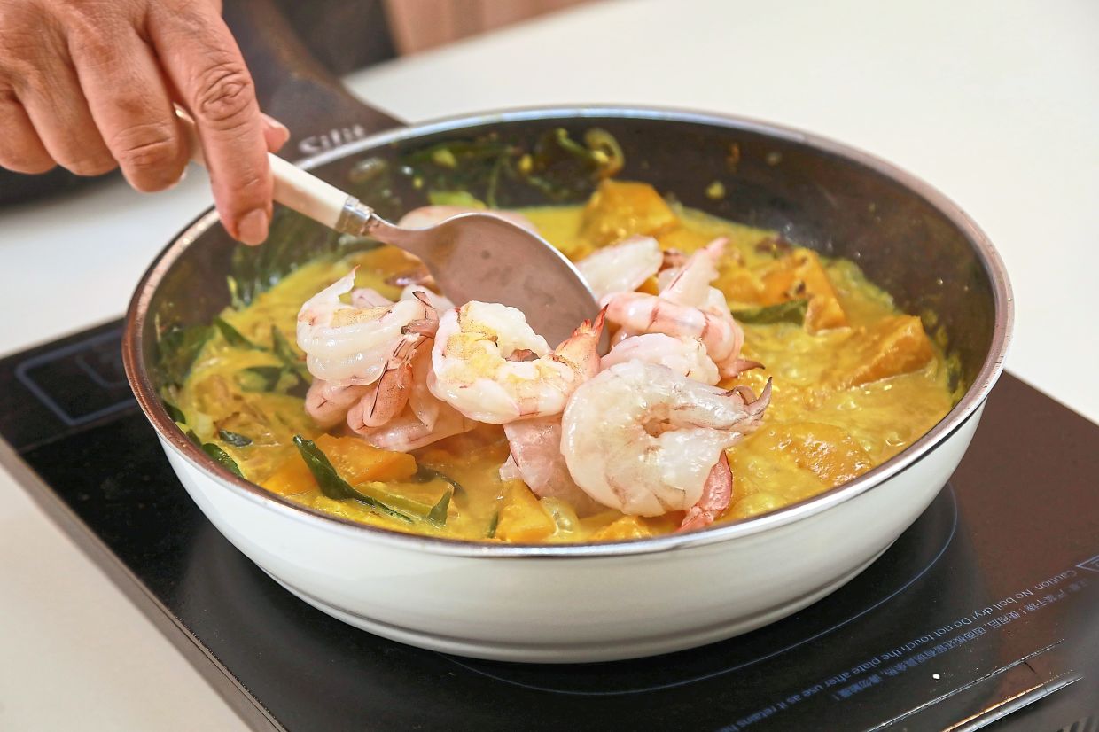 Once the pumpkin has cooked, add in the prawns.