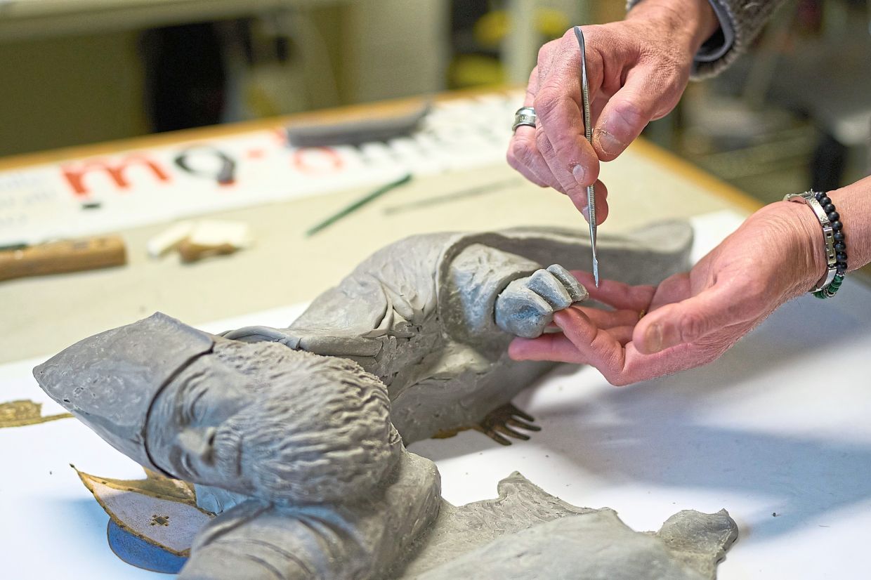 A tactile education expert transforms Titian’s Pala Gozzi into bas-relief at the Omero Tactile Museum lab. Photo: AP