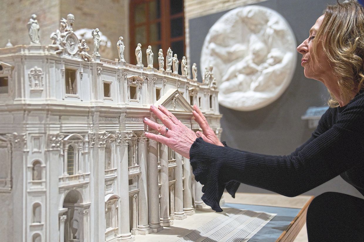 Stefania Terre, who is blind, touches a reproduction of St Peter's Basilica at the Omero Tactile Museum in Ancona, Italy. Photo: AP