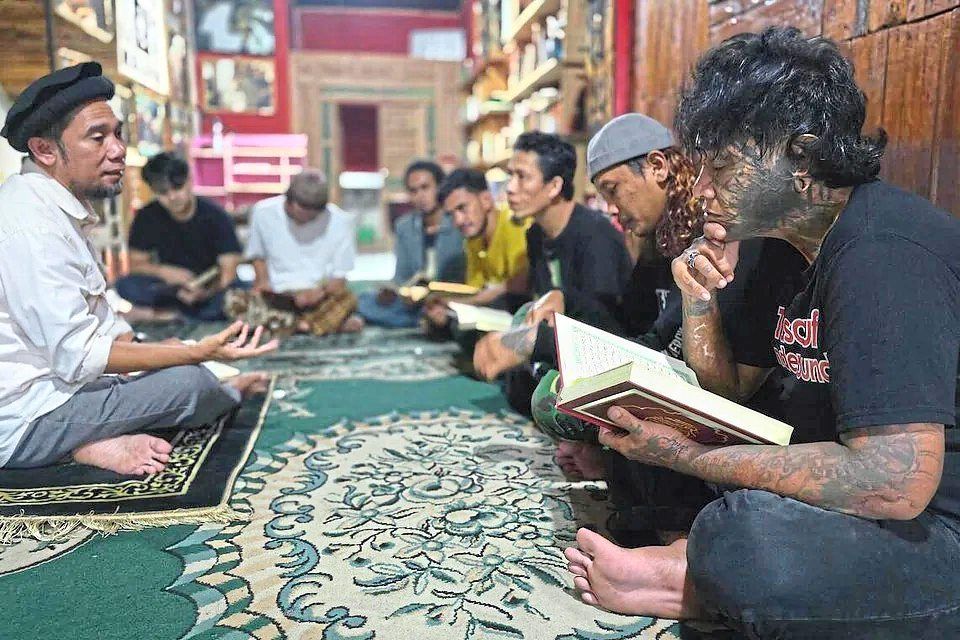 Ahmad Rezki Fauzi (far right) used to swallow 20 to 30 Tramadol pills at a time, sometimes taking stronger opioids, washed down with alcohol.