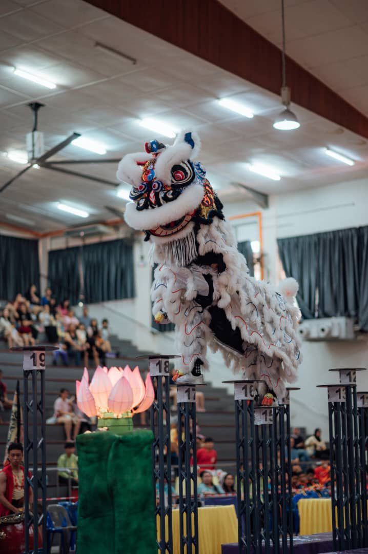 A Chung Seng performer soaring across the poles during a national-level competition in Sandakan, finishing as second runner-up.