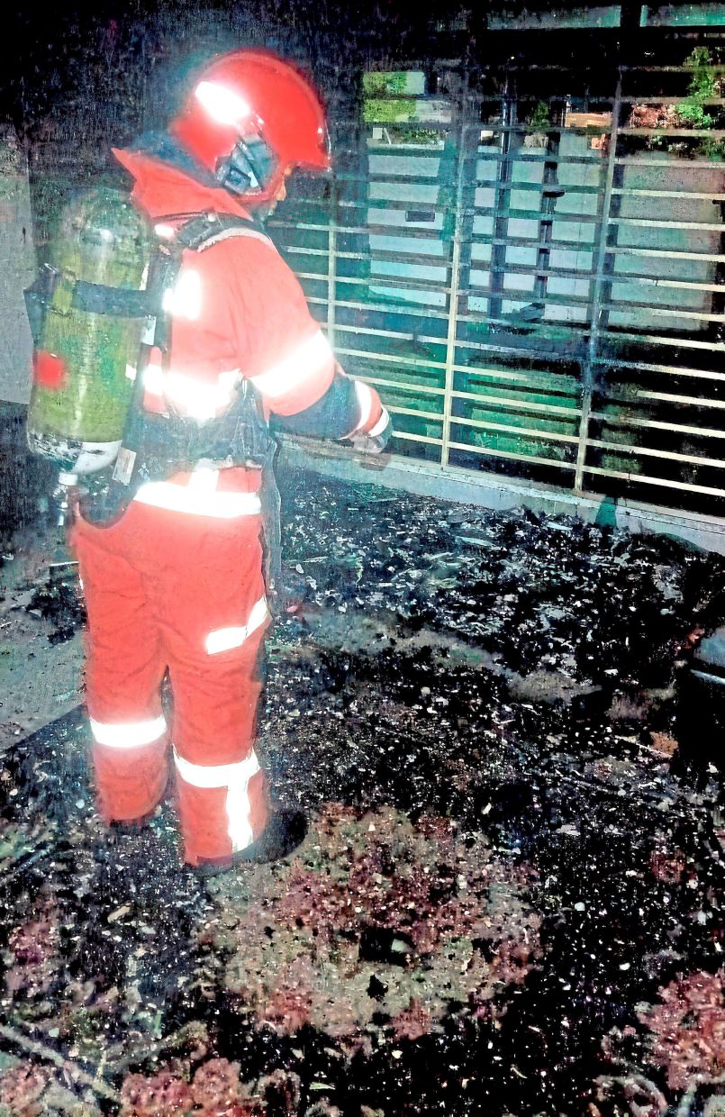 Narrow escape: The fire caused extensive damage and forced eight women to flee, with one sustaining a broken right leg. — Picture courtesy of the Fire and Rescue Department 