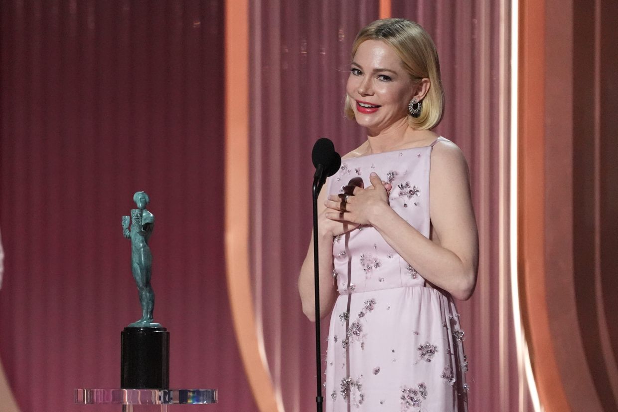 Michelle Williams accepts the award for outstanding performance by a female actor in a television movie or limited series for 'Dying For Sex'. Photo: AP