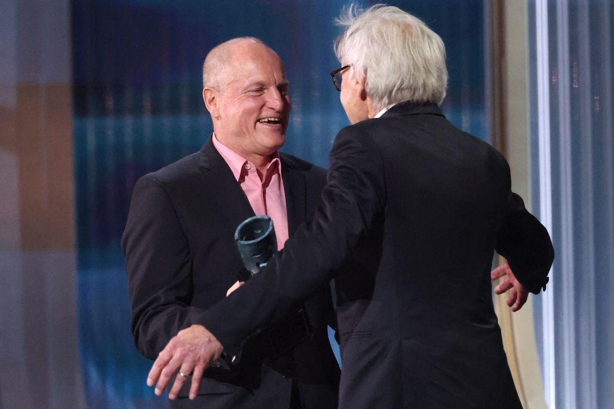 Harrison Ford accepts the Live Achievement award from presenter Woody Harrelson during the Actor Awards. Photo: Reuters