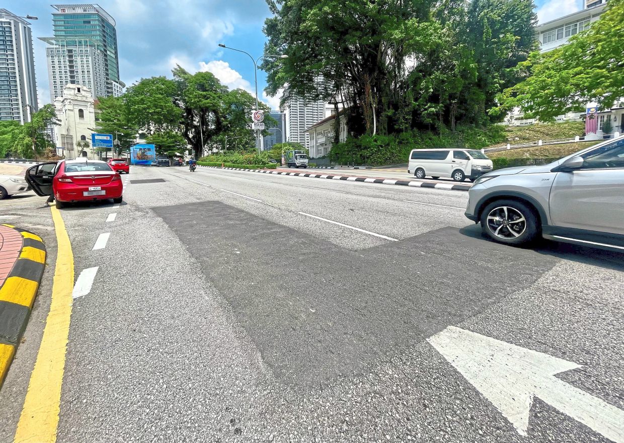A freshly patched section of road stands out against the existing surface along Jalan Sultan Hishamuddin in Kuala Lumpur, reflecting emergency repair works carried out to address road damage.