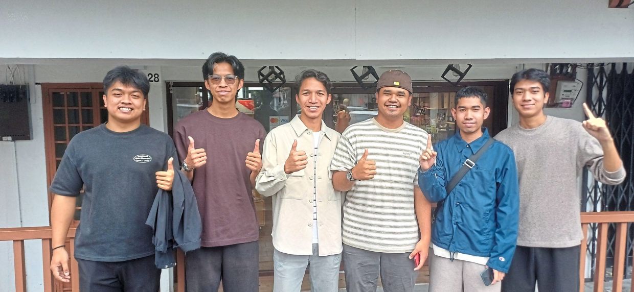 Left: A little visitor raptly watching a pheasant in an enclosure at Zoo Johor, which has undergone upgrades. — THOMAS YONG/The StarBelow: Azizul Dazmeen (left) with friends during their Chinese New Year break in Johor Baru to explore the city and shop.