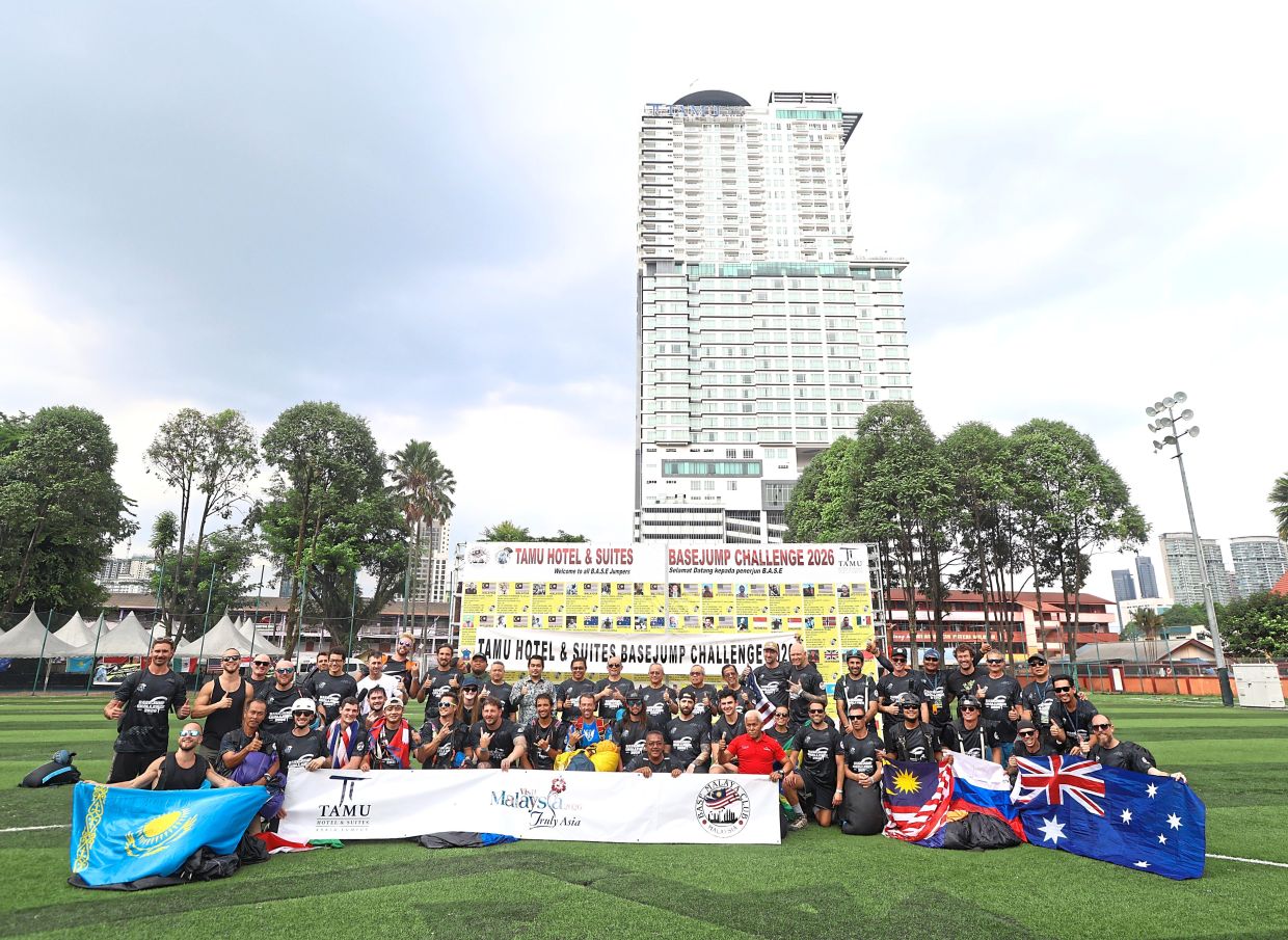 Participants posing for a group photo after the opening ceremony of the BASE jumping event.