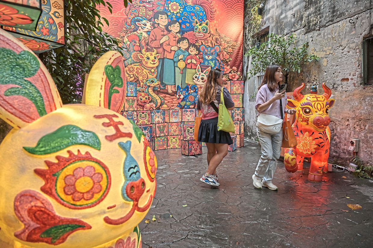 Cartoon-style illustrations depicting a family alongside a few zodiac animals form the backdrop of the art installation for the festival.