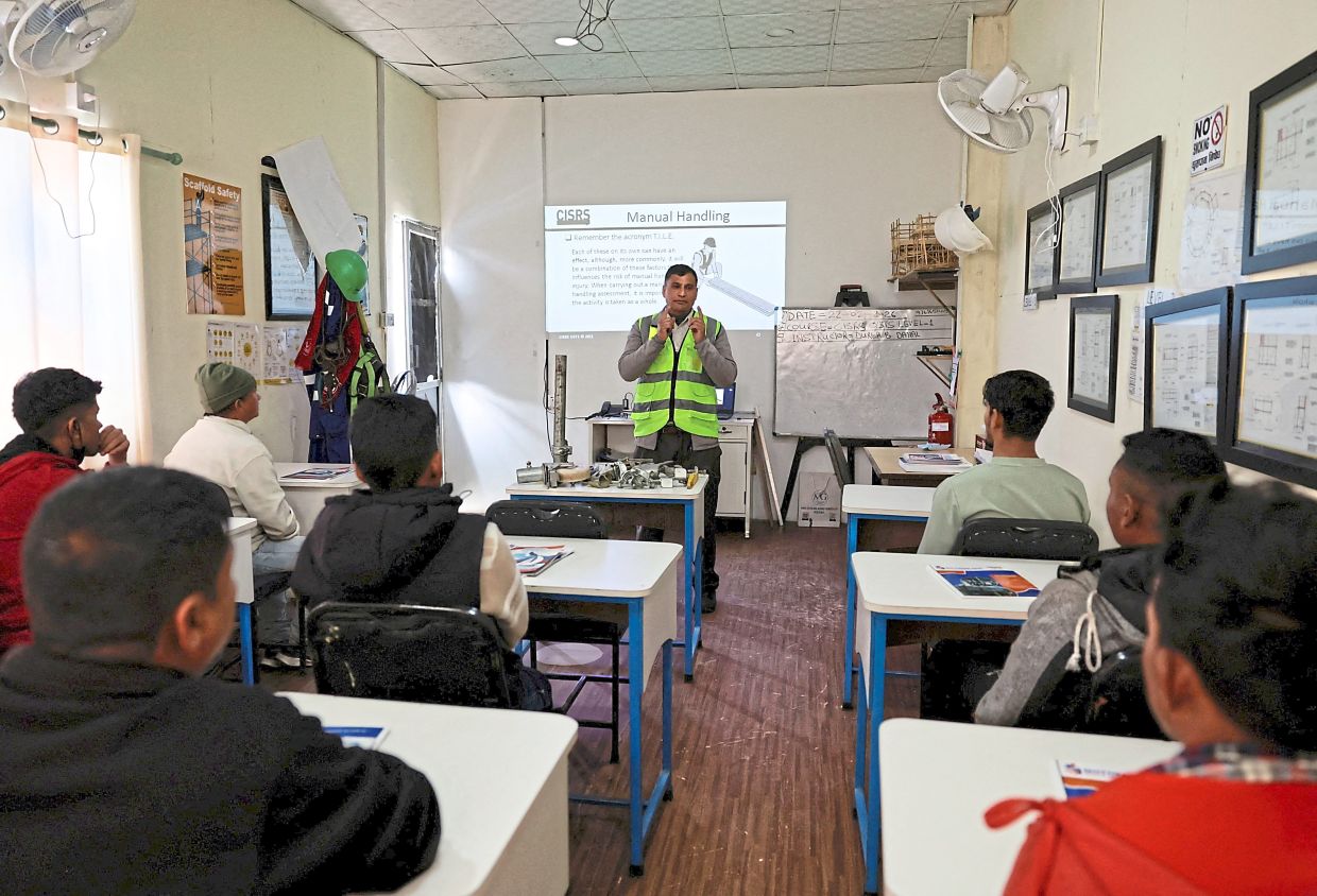 Early preparation: A trainer teaching a theory class to people planning to leave the country and apply for foreign employment at the Motherland Overseas recruitment agency. — Reuters