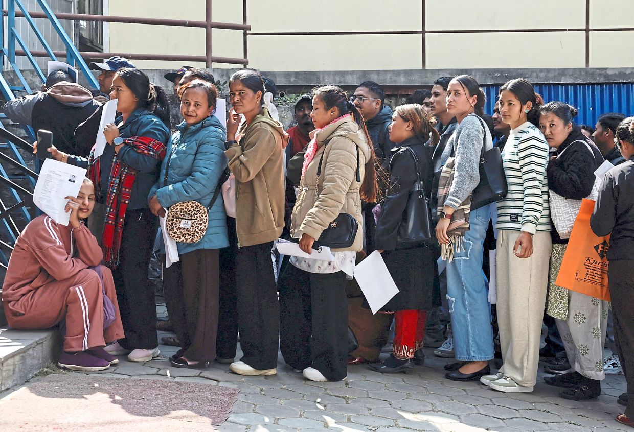 Long wait: The crowd outside the Motherland Overseas recruitment agency waiting for an interview. According to recruiter Daha, over the past six months, the number of people going for work abroad has increased. — Reuters