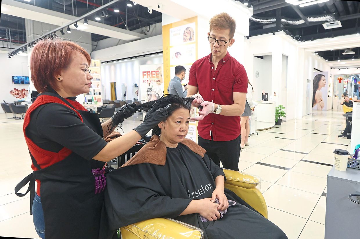 Zhang getting her hair done in Johor Baru.