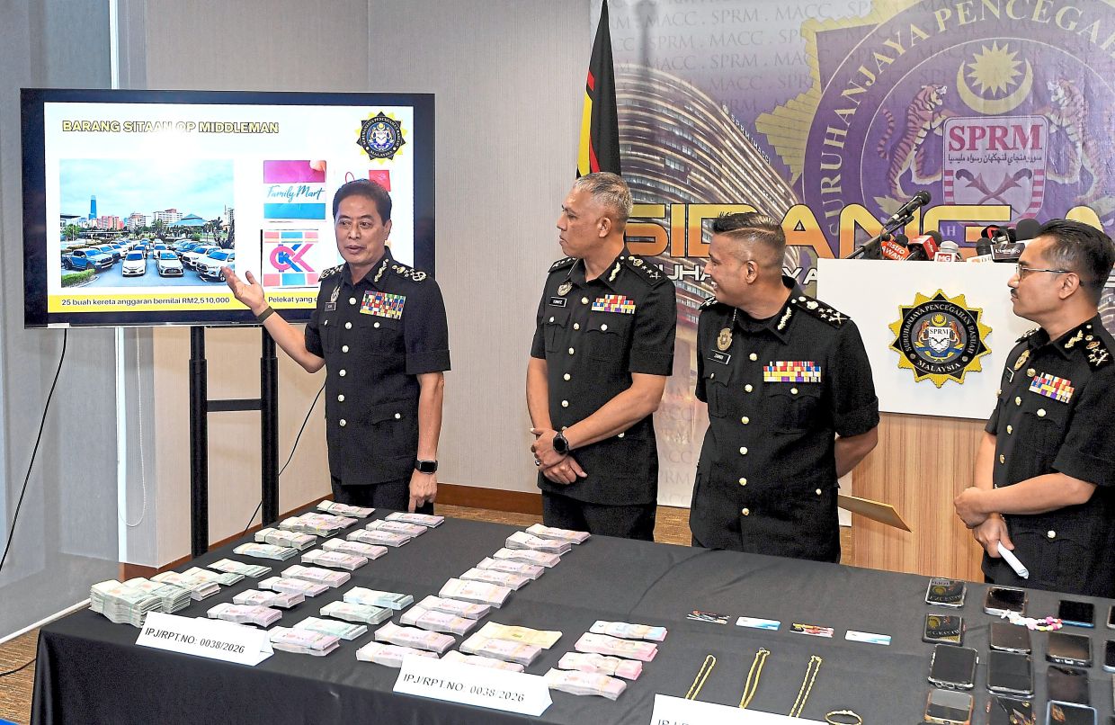 Major haul: Azam showing the seized vehicles and items during a press conference at the MACC headquarters in Putrajaya. — AZHAR MAHFOF/The Star
