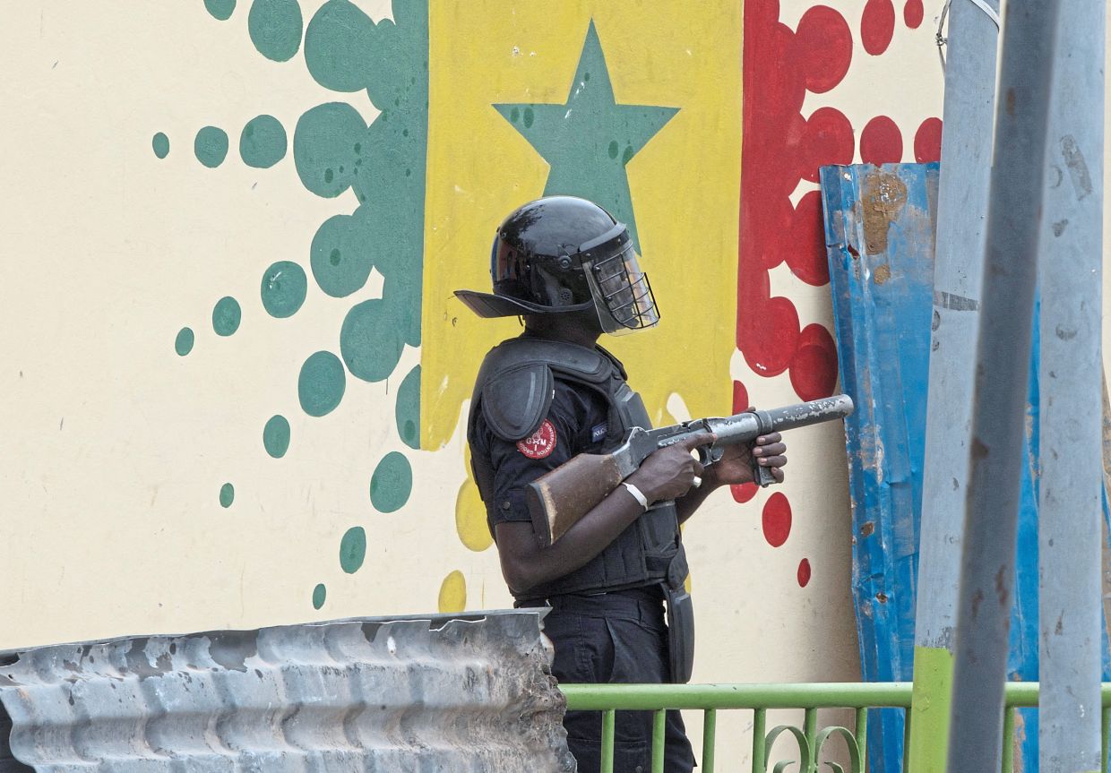 A riot police holding a tear gas gun inside Cheikh Anta Diop University campus during clashes with students as protesters demand stipends and other financial aid amid the government’s ongoing fiscal challenges.— Reuters