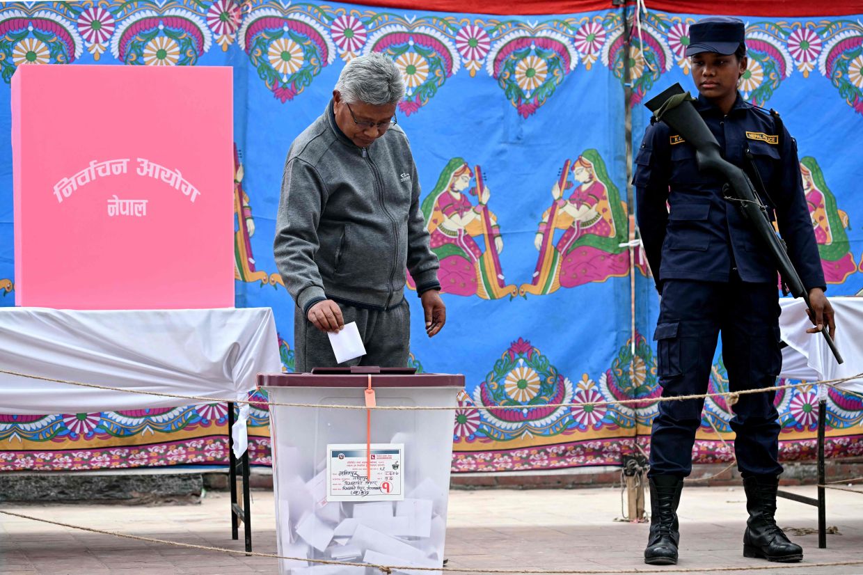 A man casting his ballot at a polling station during Nepal's general election in Lalitpur on March 5, 2026. Nepal voted on March 5, for a new parliament in a high-stakes showdown between an entrenched old guard and a powerful youth movement, six months after deadly anti-corruption protests toppled the government. - AFP
