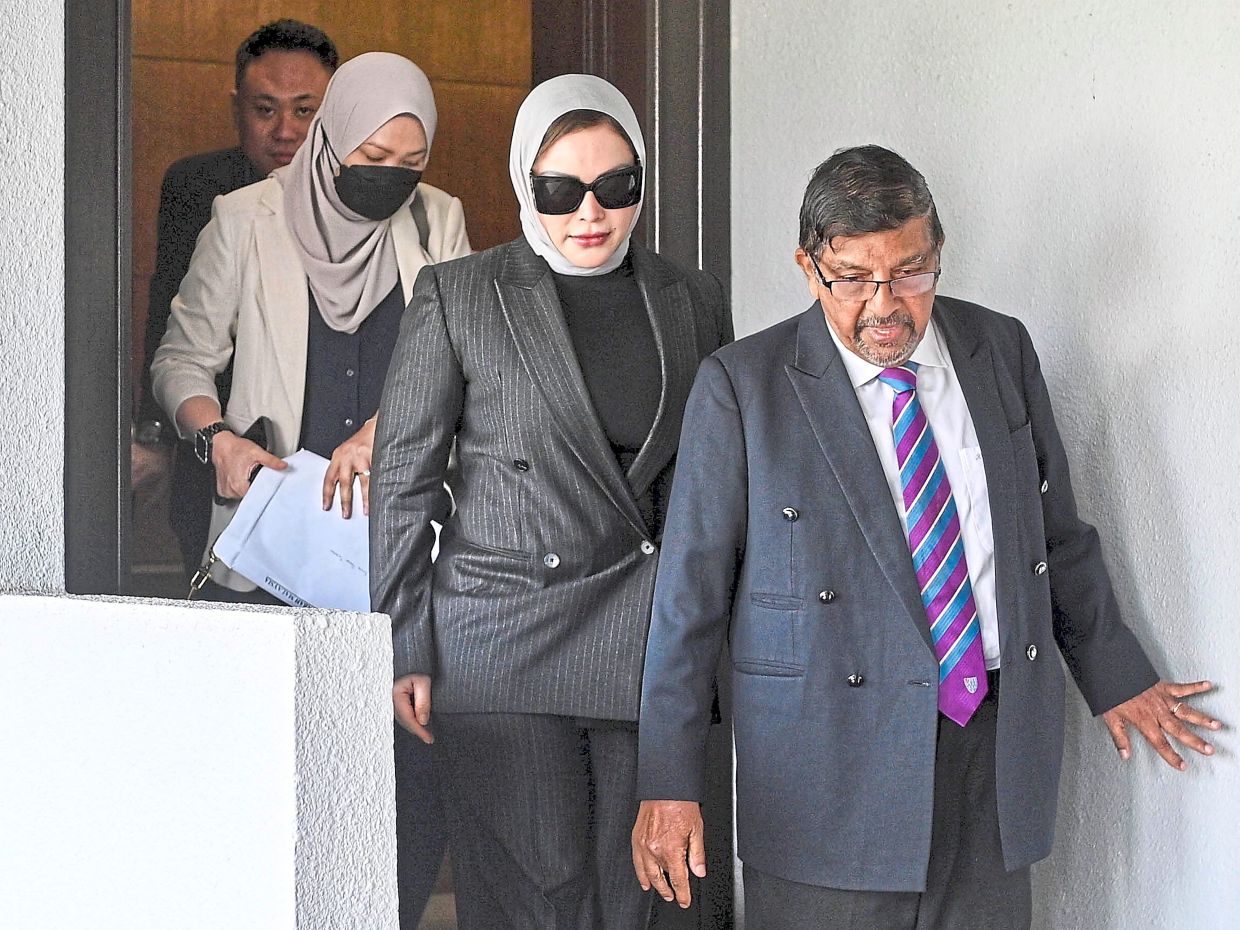 Legal spotlight: Zizie Izette (second from right) appearing at the Sessions Court yesterday. — Bernama