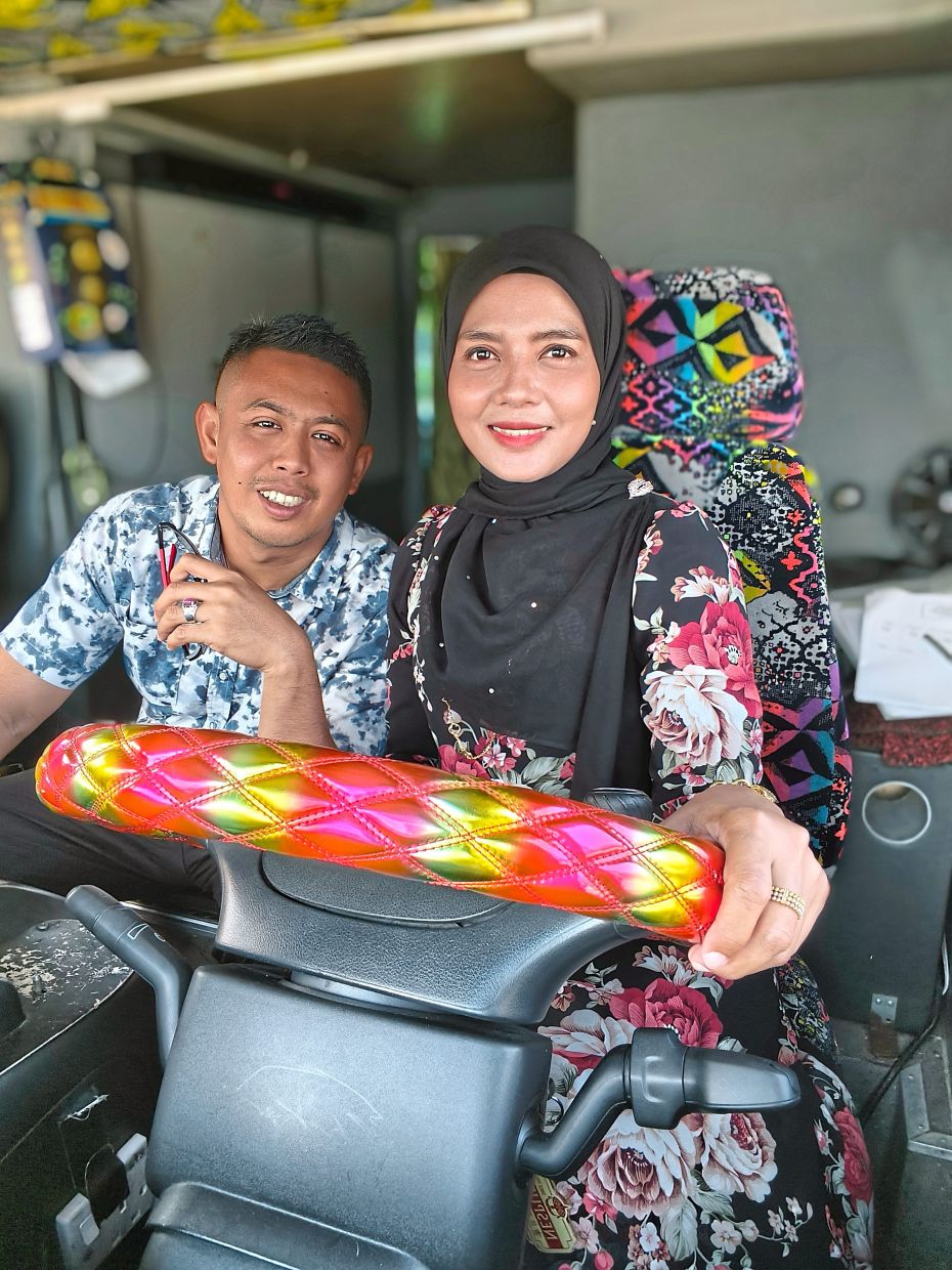 Siti Azmira with her husband Mohd Amirul Amri. They take turns driving long-distance routes.