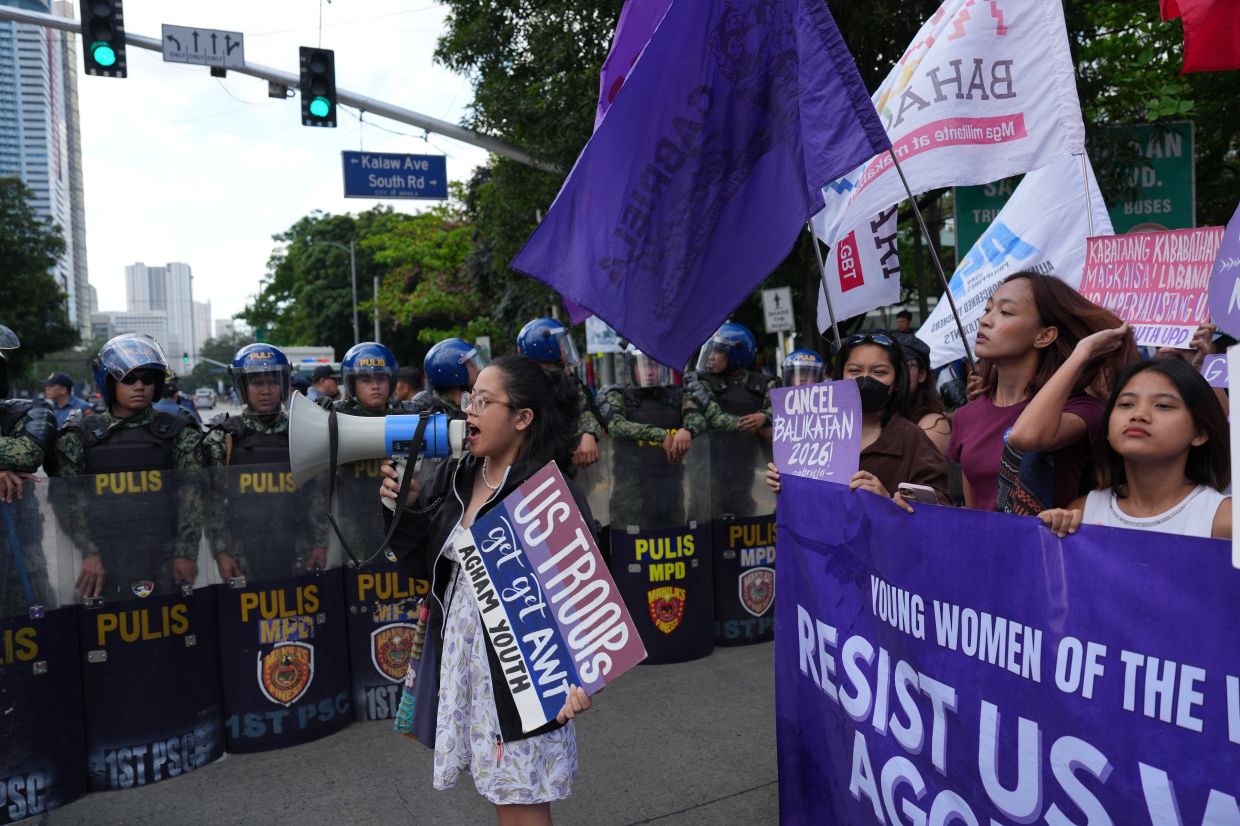 Protesters shouting slogans to condemn the Iran war as they are blocked by police during a rally near the US Embassy in Manila, Philippines on March 6, 2026. - AP 