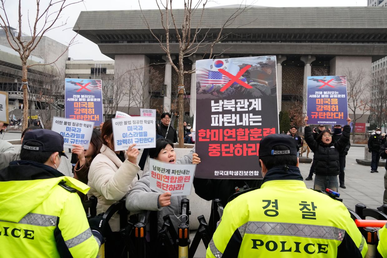 South Korean college students protesting against the US and Israel's attacks on Iran and upcoming US and South Korea military exercise near the US Embassy in Seoul, South Kore on March 6, 2026. - AP