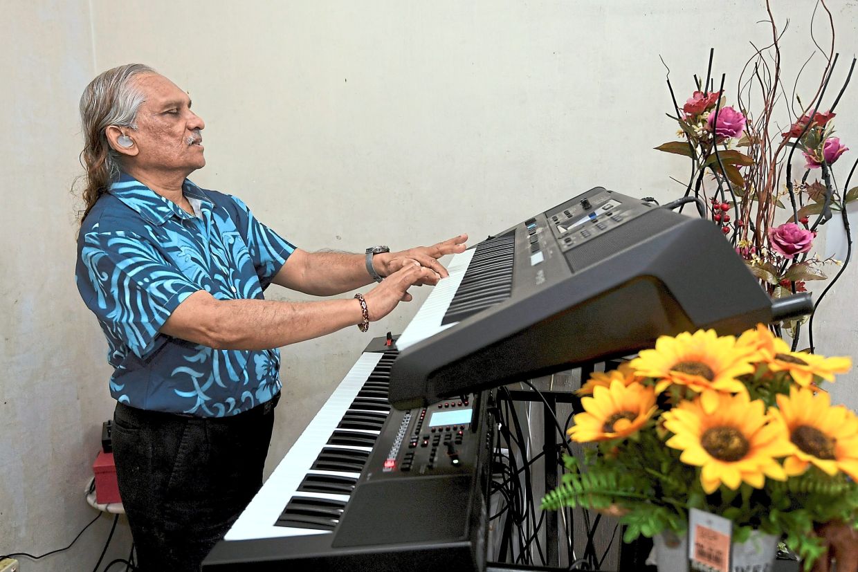 Louise plays music on his keyboard made specifically for visually-impaired pianists. It has easy-to-access buttons for changing settings.