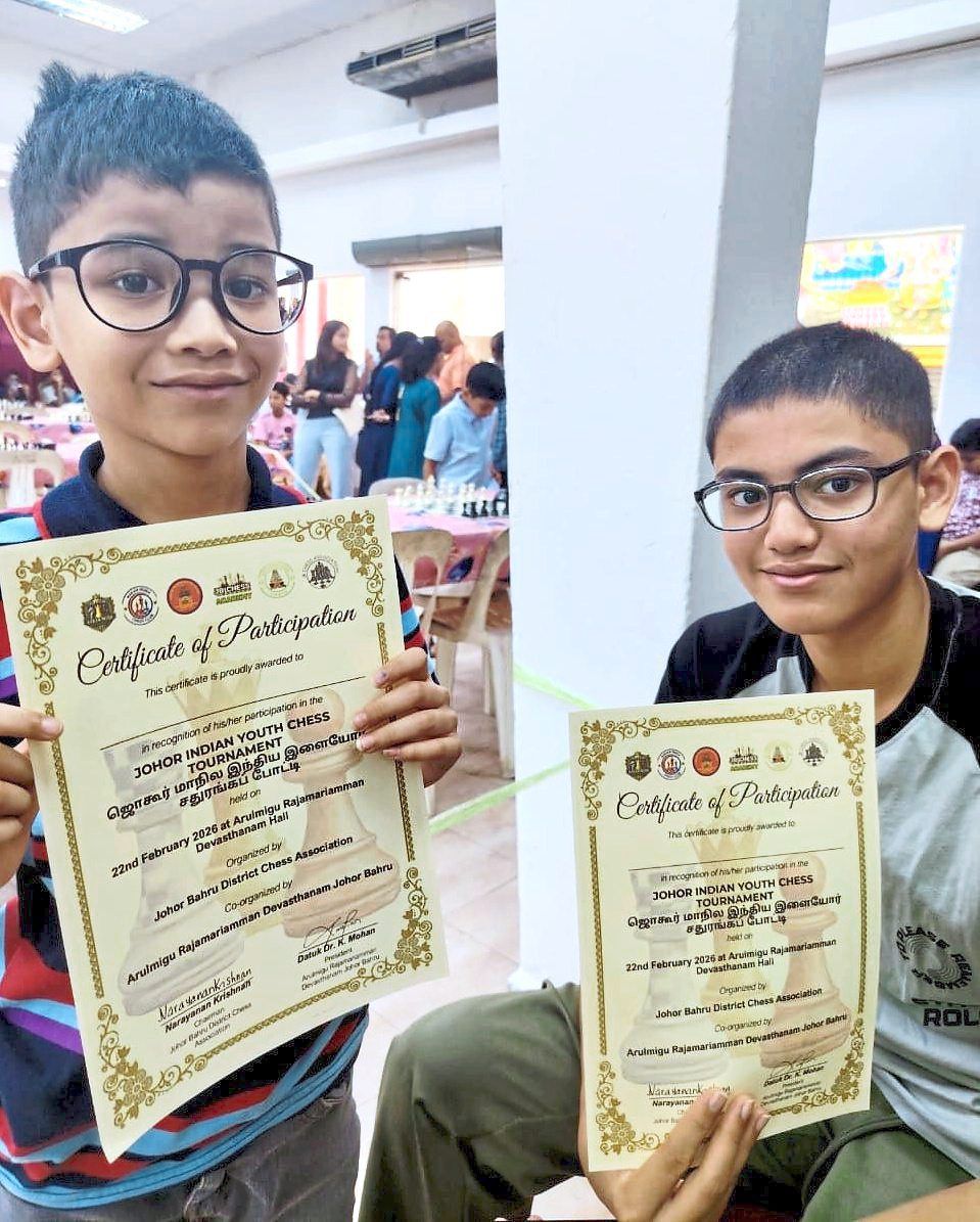 Brothers Arvin James (left) and Asher Joel with their certificates of participation.