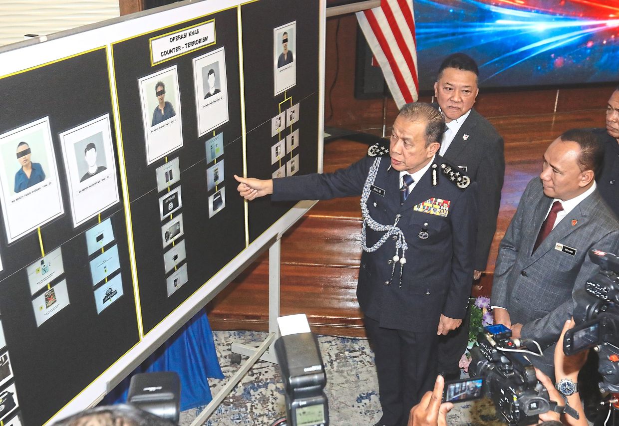 Sharing updates: Mohd Khalid (centre) speaking at the press conference at Bukit Aman in Kuala Lumpur. With him are Special Branch director Comm Datuk Ibrahim Darus (right) and Bukit Aman Special Branch E8 head Deputy Comm Datuk Azman Abd Razak. — AZLINA ABDULLAH/The Star