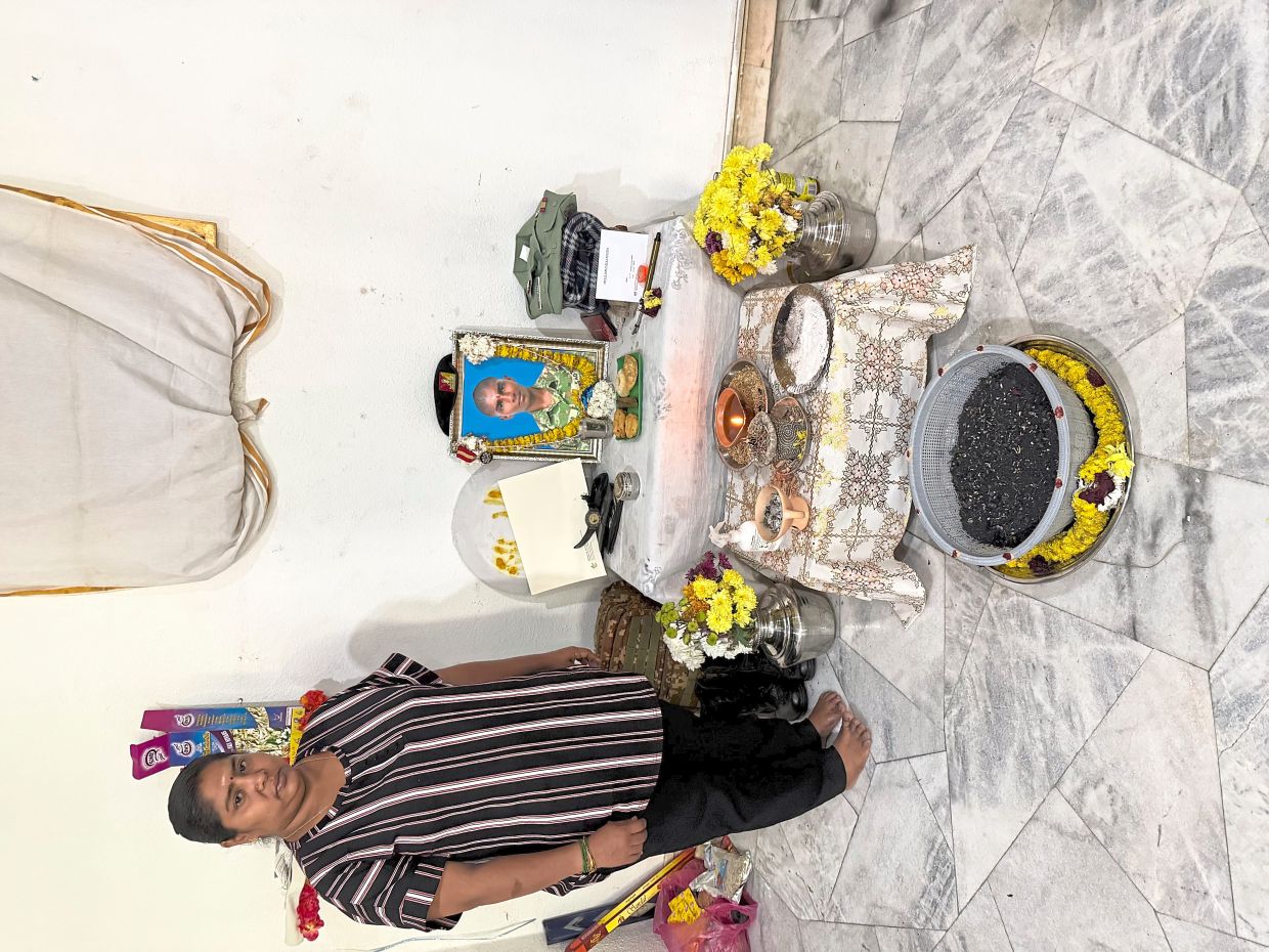 A mother’s grief: Usha standing beside the altar set up in her home for her son Indran, who died in an army camp last month. It’s the second blow for her after she lost her husband, Kayamboo, in an air crash in 2016.