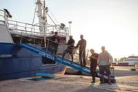 Docked and deserted, sailors wait for unpaid wages