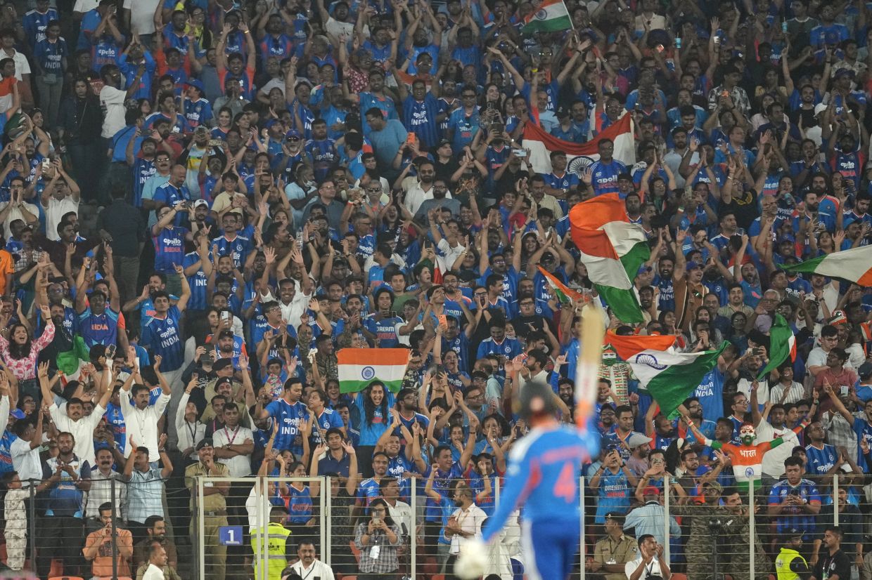 Fans cheer as India's Abhishek Sharma celebrates his fifty runs during the T20 World Cup cricket final match between India and New Zealand in Ahmedabad, India, Sunday, March 8, 2026. -- AP Photo/Rafiq Maqbool