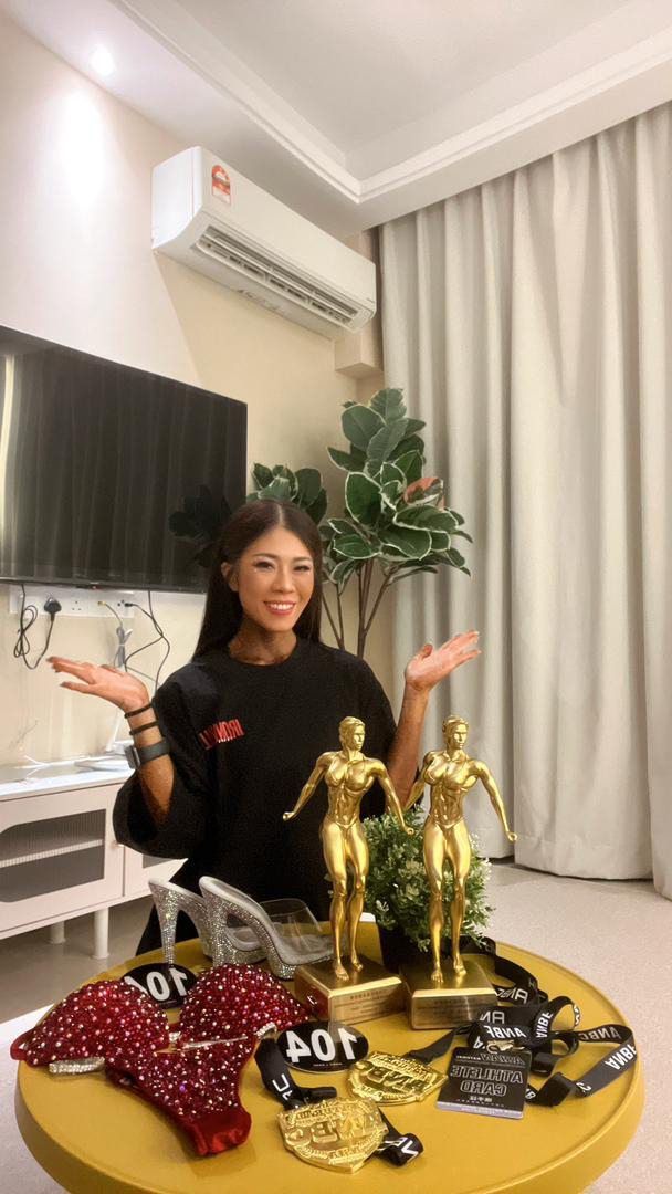 Yew with her trophies and attire from the Asian Natural Bodybuilding Competition last May.