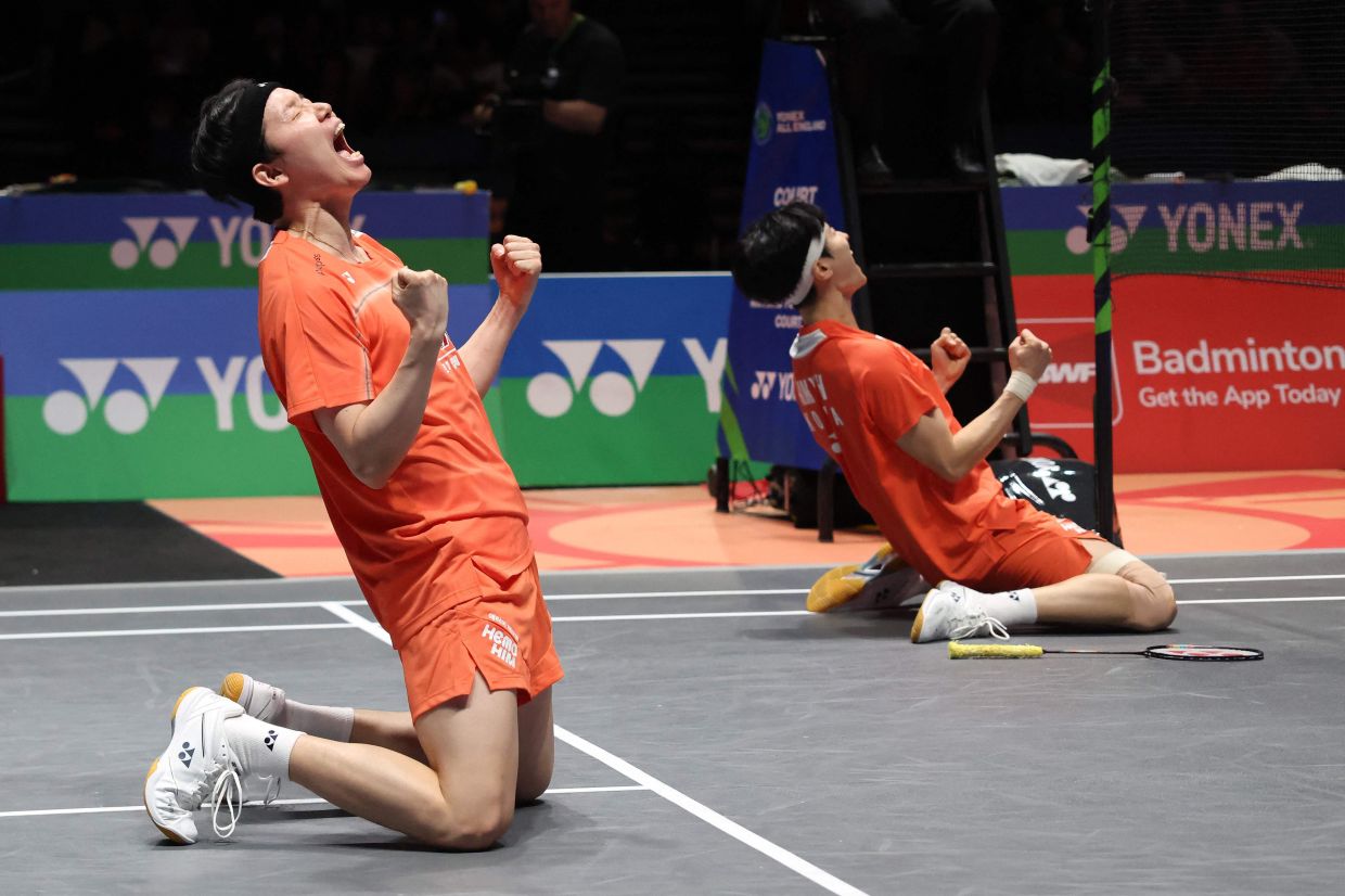 Kim Won-ho (R) and Seo Seung-jae of South Korea celebrate their victory over Aaron Chia and Soh Wooi Yik. - AFP