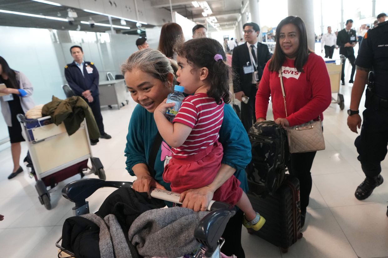 Thai peoples who were evacuated from Iran arrive at Suvarnabhumi International Airport in Samut Prakarn, Thailand, on Monday, March 9, 2026. -- AP Photo/Sakchai Lalit