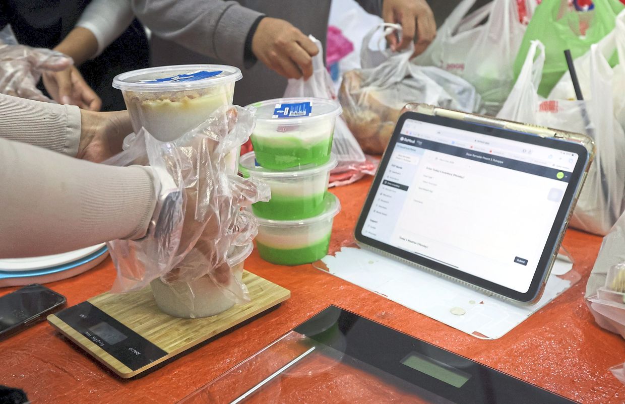 Food and drinks being weighed and recorded to facilitate monitoring with stickers affixed to indicate the items are safe for consumption.