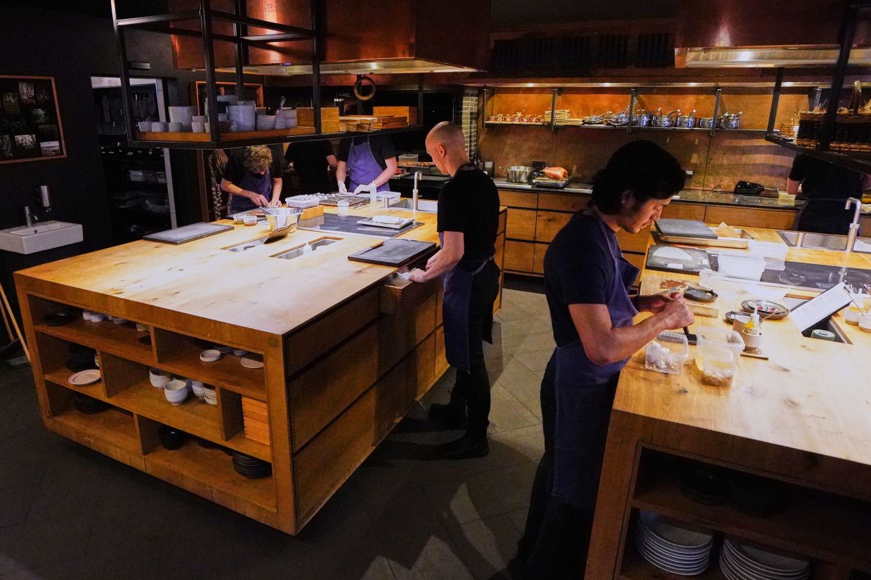 Chiefs prepare food at the restaurant Kadeau in Copenhagen, Denmark. — AP Photo/James Brooks