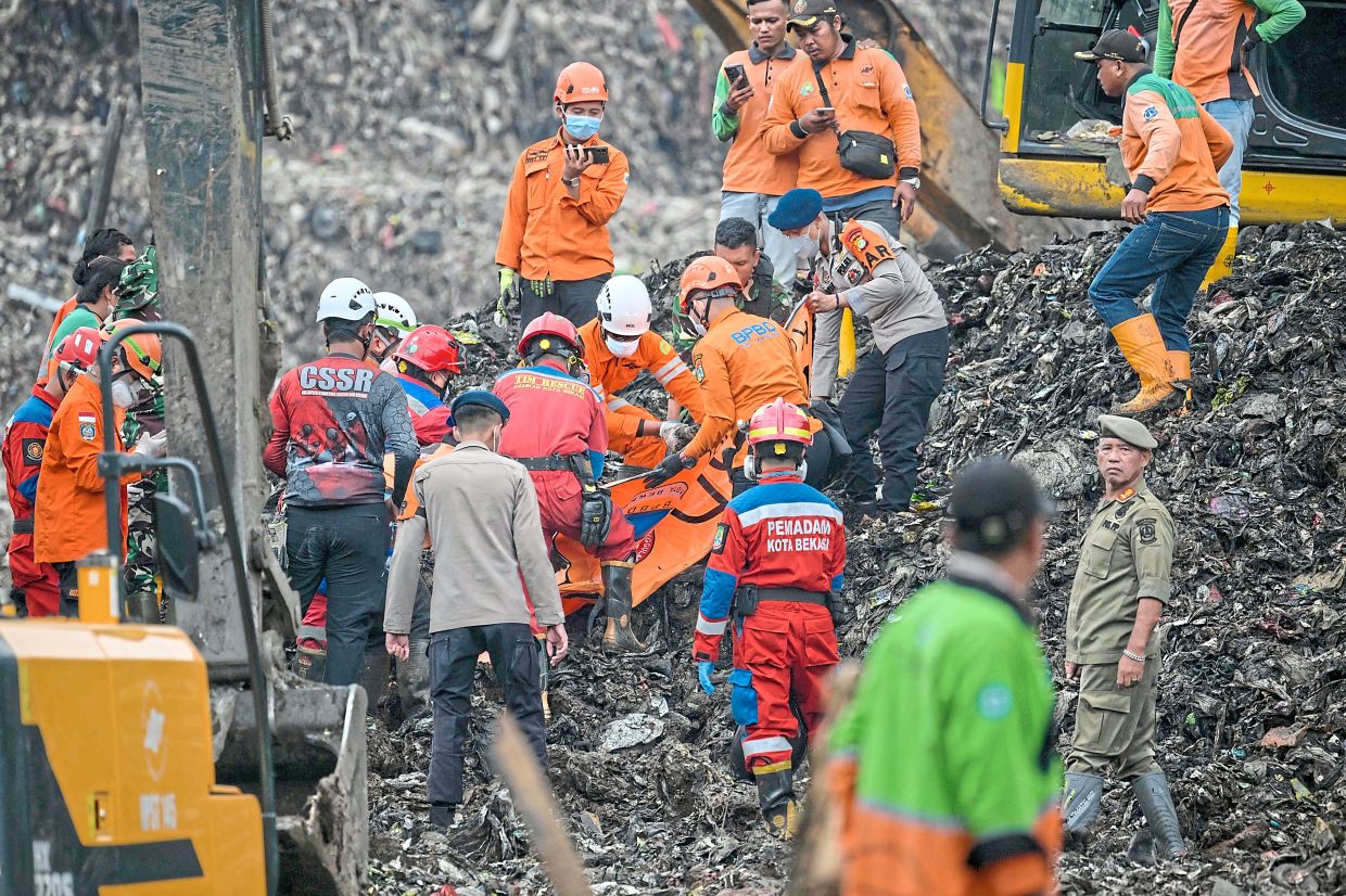 Rescue workers preparing to evacuate a victim. - AFP