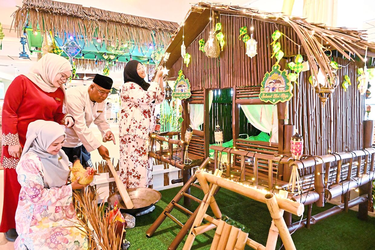 Shangri-La Golden Sands staff adding the finishing touches to a mini replica of P. Ramlee’s house.