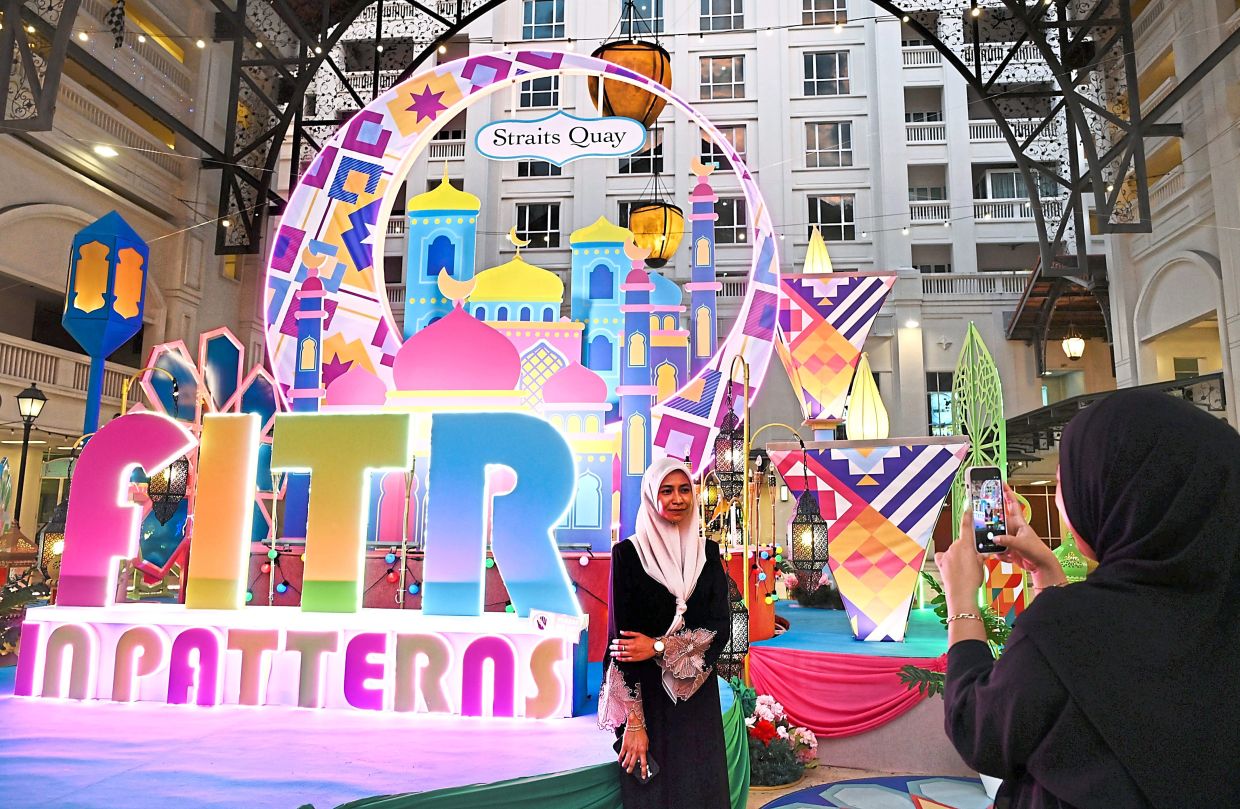 Visitors to Straits Quay Retail Marina taking photos at the colourful outdoor installation.