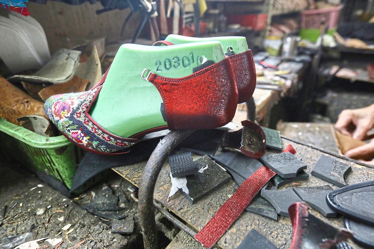 A pair of glittery, beaded dance shoes that the couple make and sell at their shop in Kuala Lumpur.