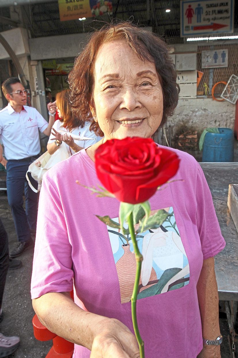 Teoh smiling after receiving a rose on International Women’s Day.