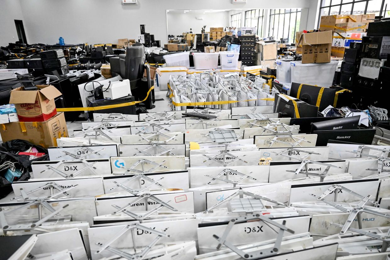 A general view shows seized equipment confiscated from cyberscam operation centres at the Commissariat of Phnom Penh Municipal Police in Phnom Penh on March 11, 2026. — AFP