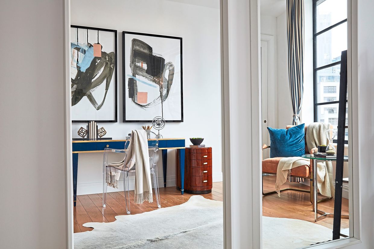 A small office is made to feel open and bright through the use of mirrors.