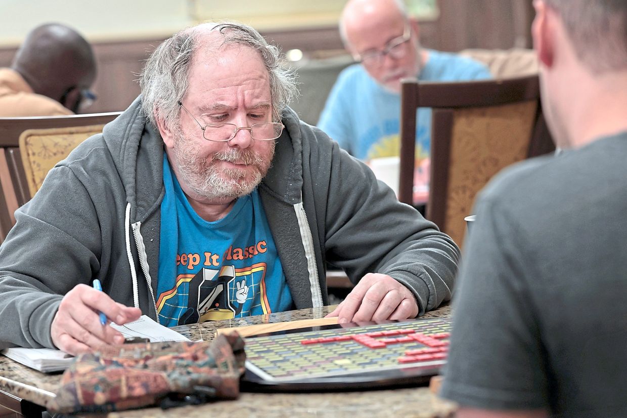 Jacobson (left) ponders his next move while playing Scrabble with Moch.