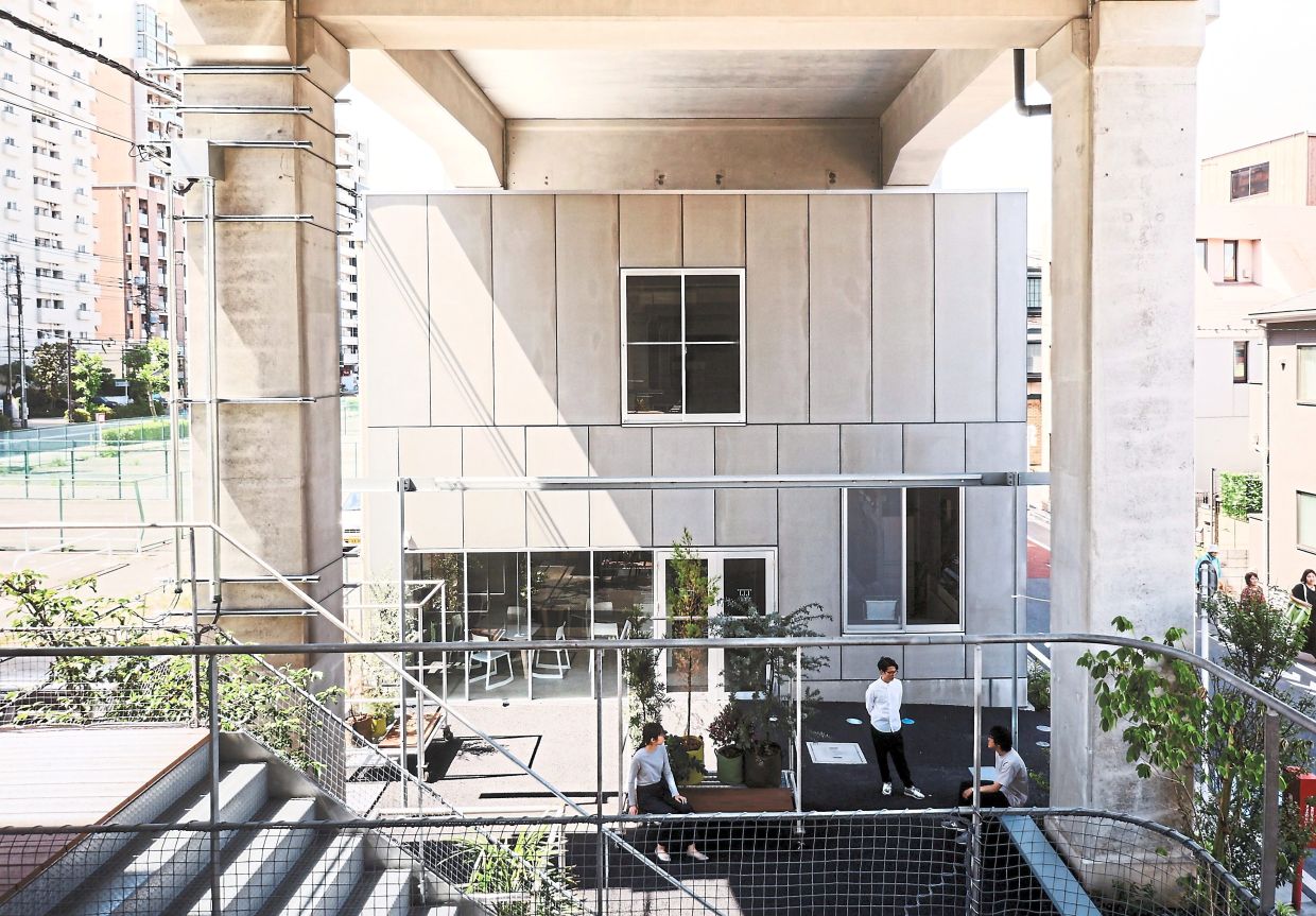 A photo at the exhibition shows Koca@Kamata, a creative hub and incubation space established in 2019 beneath an elevated railway line in South Tokyo.