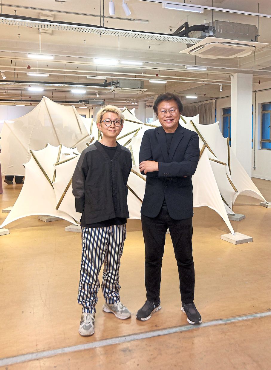 (from left) Yutaro Muraji and Dr Tan Loke Mun in front of the pavilion created by structural engineer Yuta Shimoda using a membrane tensegrity system but constructed with bamboo sourced from Malaysian forests.