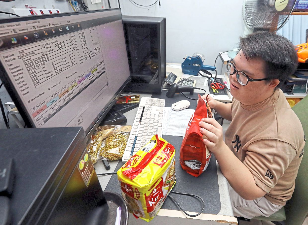 Lim confidently handles his duties at his family's grocery store.