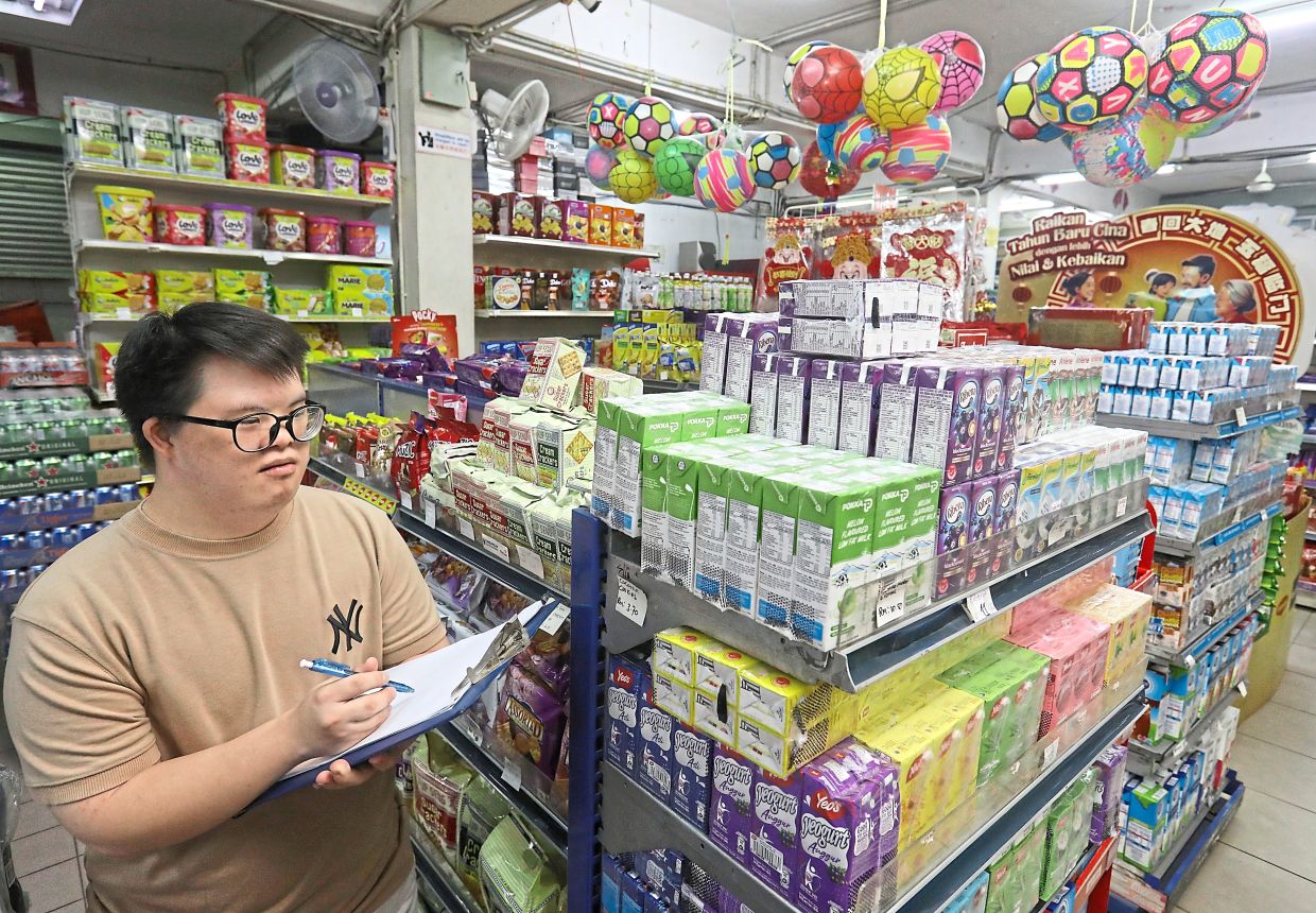 One of Lim’s tasks at the shop is helping to count and organise stock.
