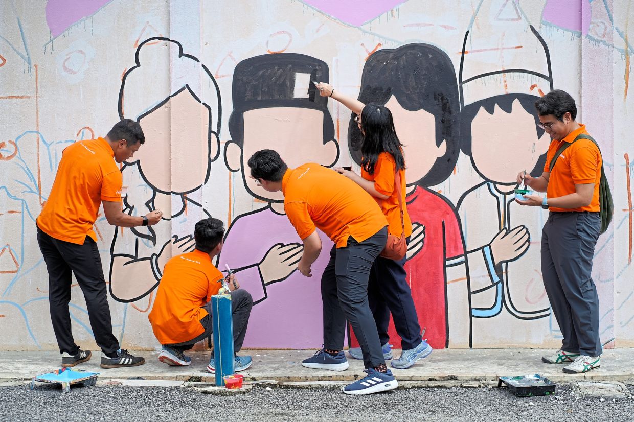 Nearly 100 KWAP employees volunteered in various activities, including painting murals, to help create a brighter and more welcoming learning environment.