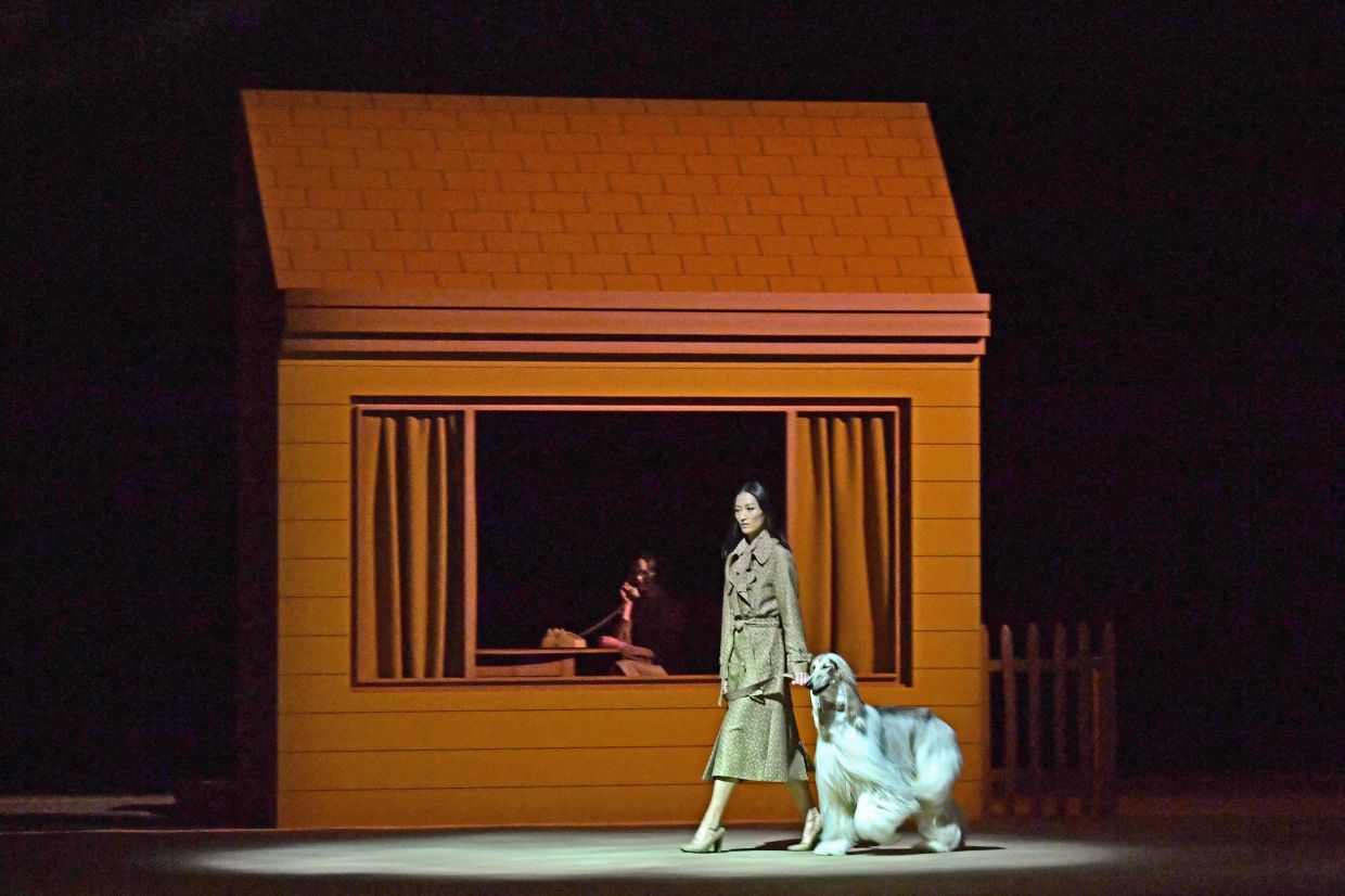 A model walks with a dog on the runway for Coach during New York Fashion Week in 2022. Photo: AFP